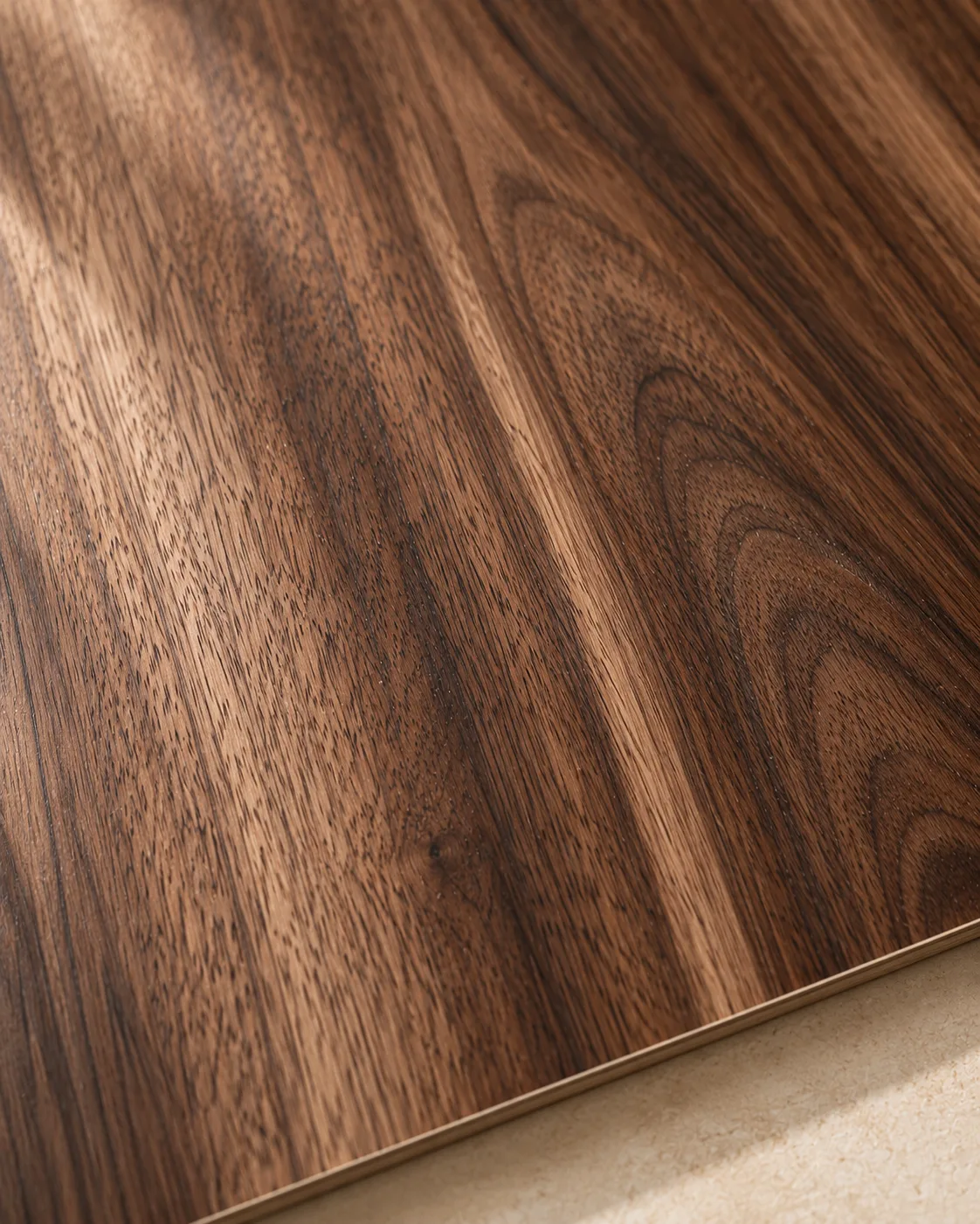 Warm walnut veneer with vertical grain and a clean sheet edge